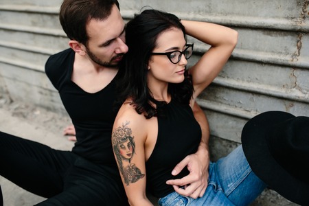 man and woman posing for the camera on a background gray wallの写真素材