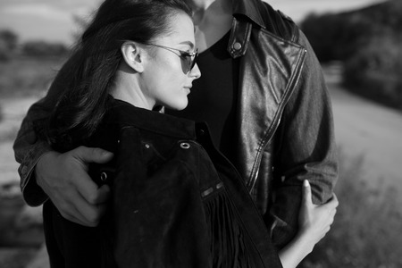 Beautiful young couple in embrace each other near the riverの写真素材