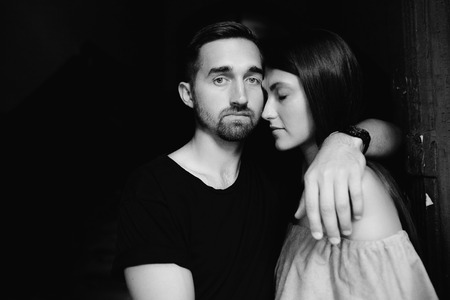 couple posing in the doorway posing on cameraの写真素材