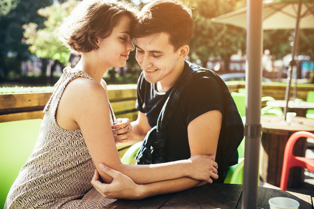 guy and the girl sitting in a cafe outsideの写真素材
