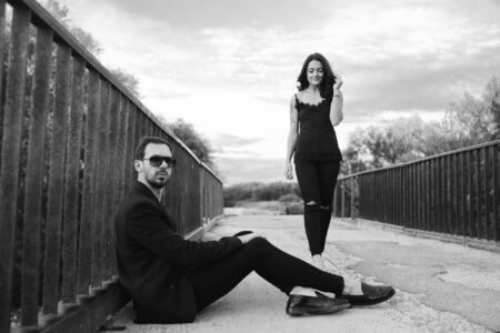 girl goes to the guy on a bridgeの写真素材