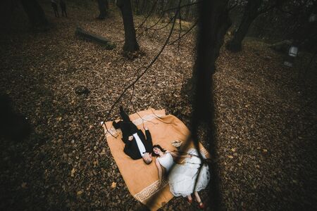 Couple lying down at the autumn park