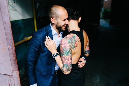 man and woman hugging in the doorway of an abandoned buildingの写真素材