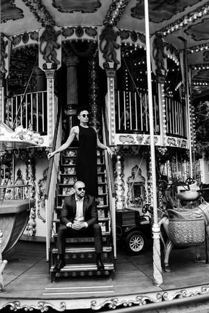 adult man and woman on merry go round carouselの写真素材