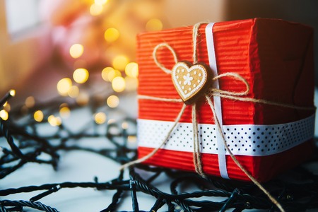 gift is on the table, a garland in the backgroundの写真素材