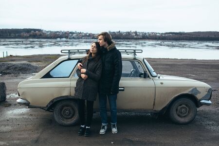young beautiful couple on the ice of a frozen lake posing for the cameraの写真素材