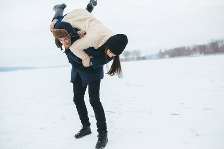 man and woman having fun and playing outdoorsの写真素材