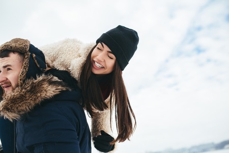 man and woman having fun and playing outdoorsの写真素材