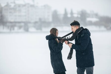 young couple having fun in the park, in winter holidaysの写真素材