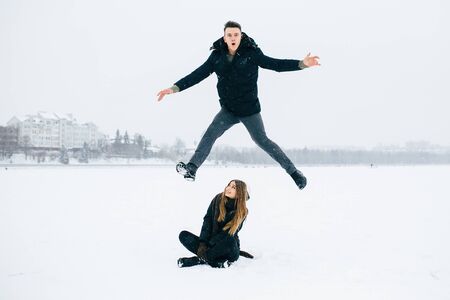 young couple having fun in the park, in winter holidaysの写真素材