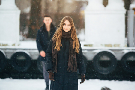 young couple having fun in the park, in winter holidaysの写真素材