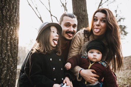 cheerful and happy family in autumn park, portrait photographyの写真素材