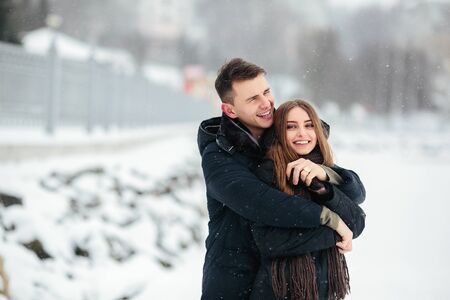 young couple having fun in the park, in winter holidays