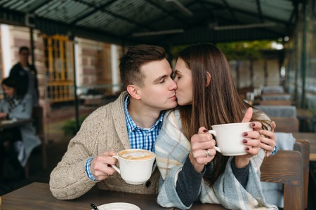Couple sitting at sidewalk cafeの写真素材