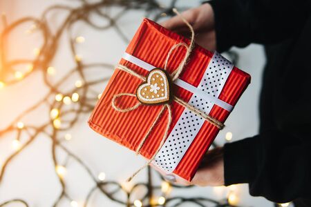 girl holding a Christmas gift in hand
