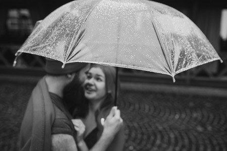 guy and girl under an umbrellaの写真素材