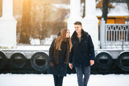 couple posing in a snowy park