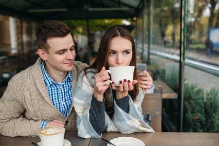 Couple sitting at sidewalk cafeの写真素材