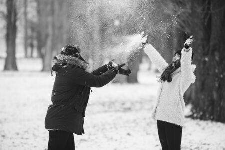 boy and girl playing with snowの写真素材