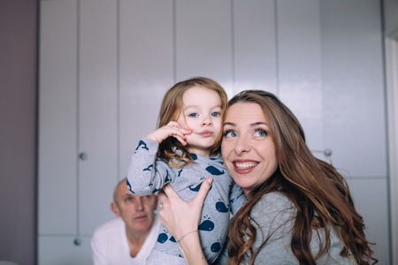 Mother and baby daughter together in the bedroomの写真素材