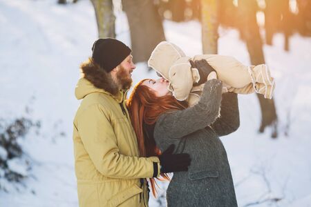 Dad mom and baby in the parkの写真素材