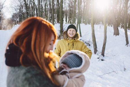Dad mom and baby in the parkの写真素材