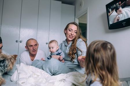 Family playing on bed in the bedroomの写真素材