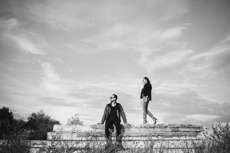 young beautiful couple posing against the skyの写真素材