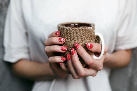 Young woman holding decorative cupの写真素材