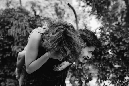 man carries a girl on his backの写真素材