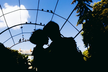 silhouette of couple on a sky backgroundの写真素材