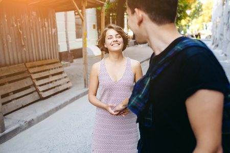 couple walking on the street holding handsの写真素材