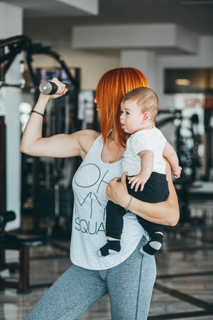 Young mother with her young son in the gymの写真素材
