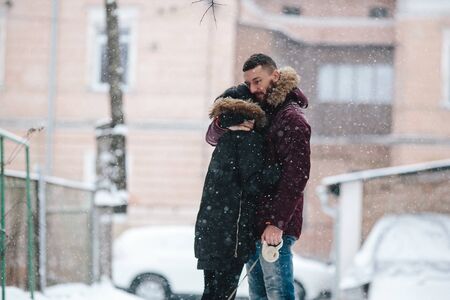 couple posing on a snowy street