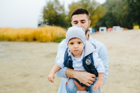 Dad with little son in her armsの写真素材