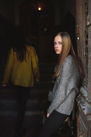 beautiful woman near the old doorsの写真素材