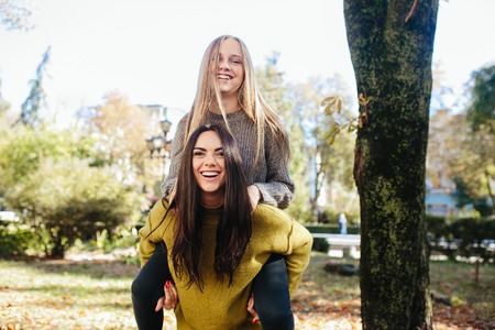 Two girls having fun in the parkの写真素材