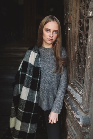 beautiful woman near the old doorsの写真素材