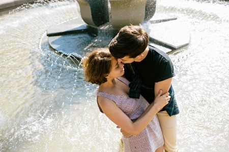 beautiful young couple at the fountainの写真素材