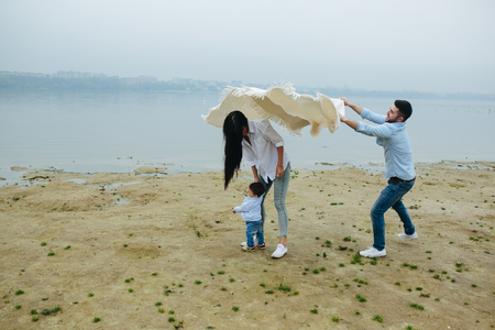 Young family together in nature with a little boyの写真素材
