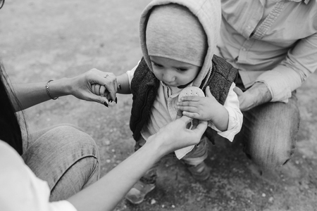 Happy young family with a little boy in nature