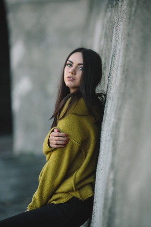 Fashion girl posing against wall