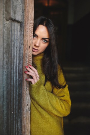 beautiful woman near the old doorsの写真素材