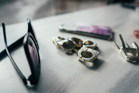 sunglasses and rings on a tableの写真素材