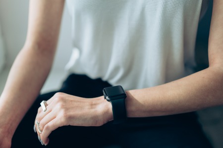 Slender girl with a smart clock on her arm