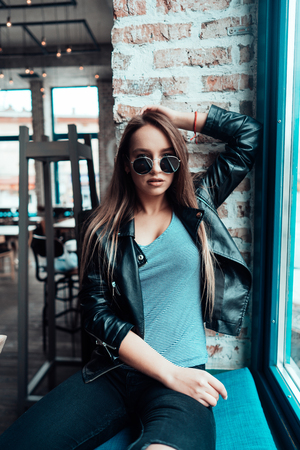 Beautiful girl in sunglasses posing on cameraの写真素材
