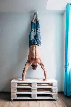 Man posing on camera, standing upside downの写真素材