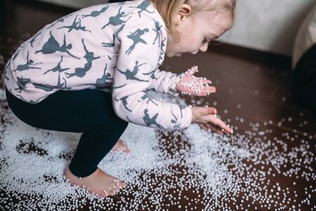 Little girl is playing with foam ballsの写真素材