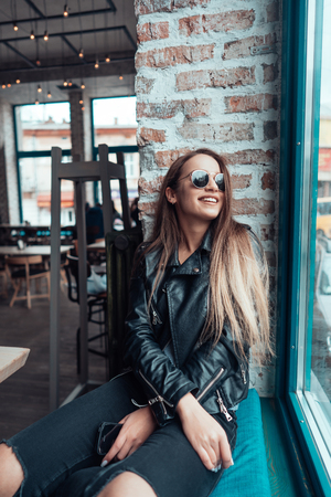 Beautiful girl in sunglasses posing on cameraの写真素材