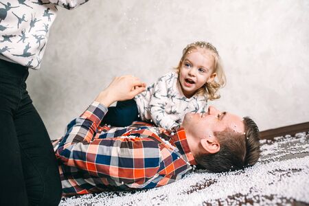 Dad plays with his daughter on the floor